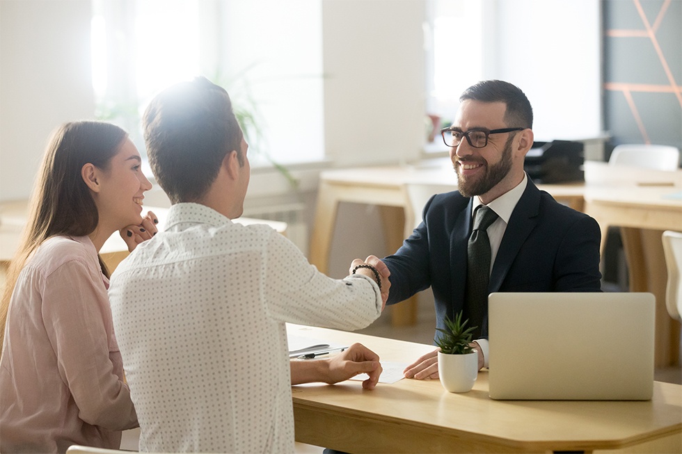 Insurance agent closing a sale with a potential client.
