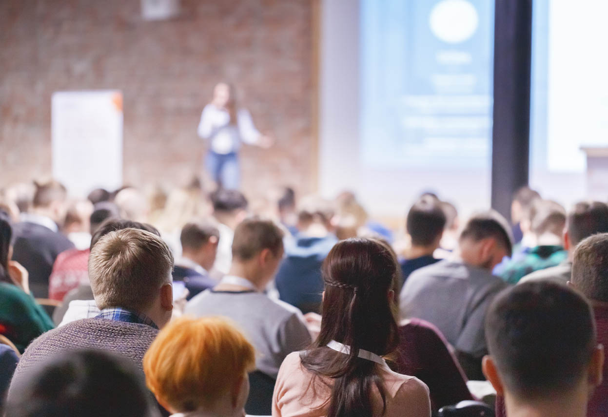An image of an insurance agent presenting to an audiance.