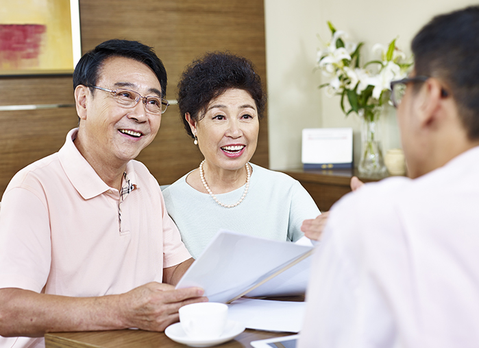 Insurance agent meeting with a husband and wife during the AEP season.